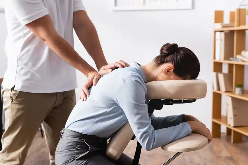 A massage therapist working on a patient