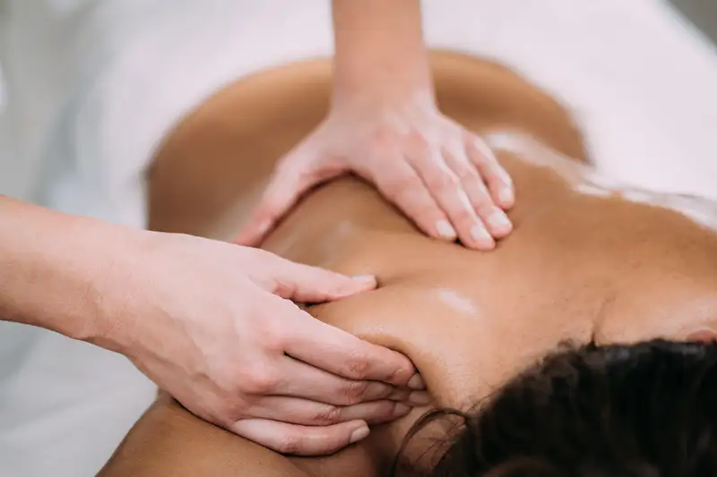 A massage therapist working on a patient