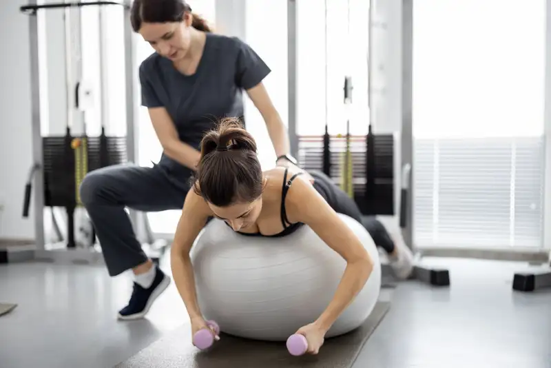 A physiotherapist working with a patient on rehab exercises